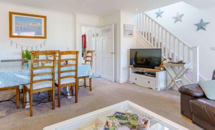 The view from the settees, the table seats 6 comfortably, the TV has surround sound, and also is a smart TV.  We like to see collections of shells in